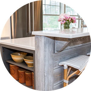 Custom kitchen island with quartz countertop, wood paneling, and stainless appliances by California HarborCrest Kitchen Design